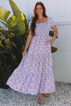 Purple floral maxi dress by Dear-Lover with short bubble sleeves, shirred high waist, and flowing fabric.