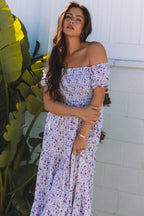 Purple floral maxi dress with short bubble sleeves, shirred high waist, made of lightweight polyester, by Dear-Lover Dropshipping.