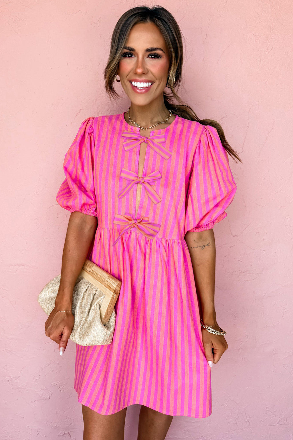 Rose striped print mini dress with bow detail, short puff sleeves, made of polyester, perfect for casual or semi-formal occasions.
