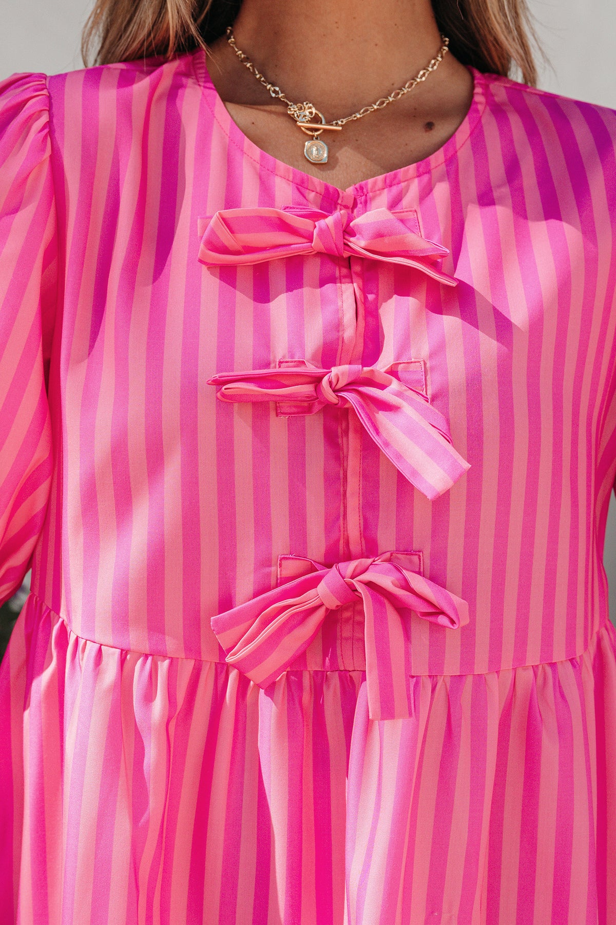 Rose striped print mini dress by Dear-Lover with bow detail, short puff sleeves, and a fitted silhouette in polyester fabric.