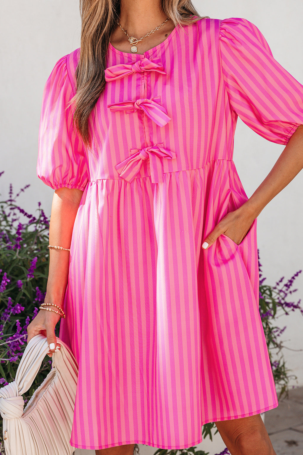 Rose-striped print mini dress with bow detail, short puff sleeves, lightweight polyester, stylish and feminine for casual wear.