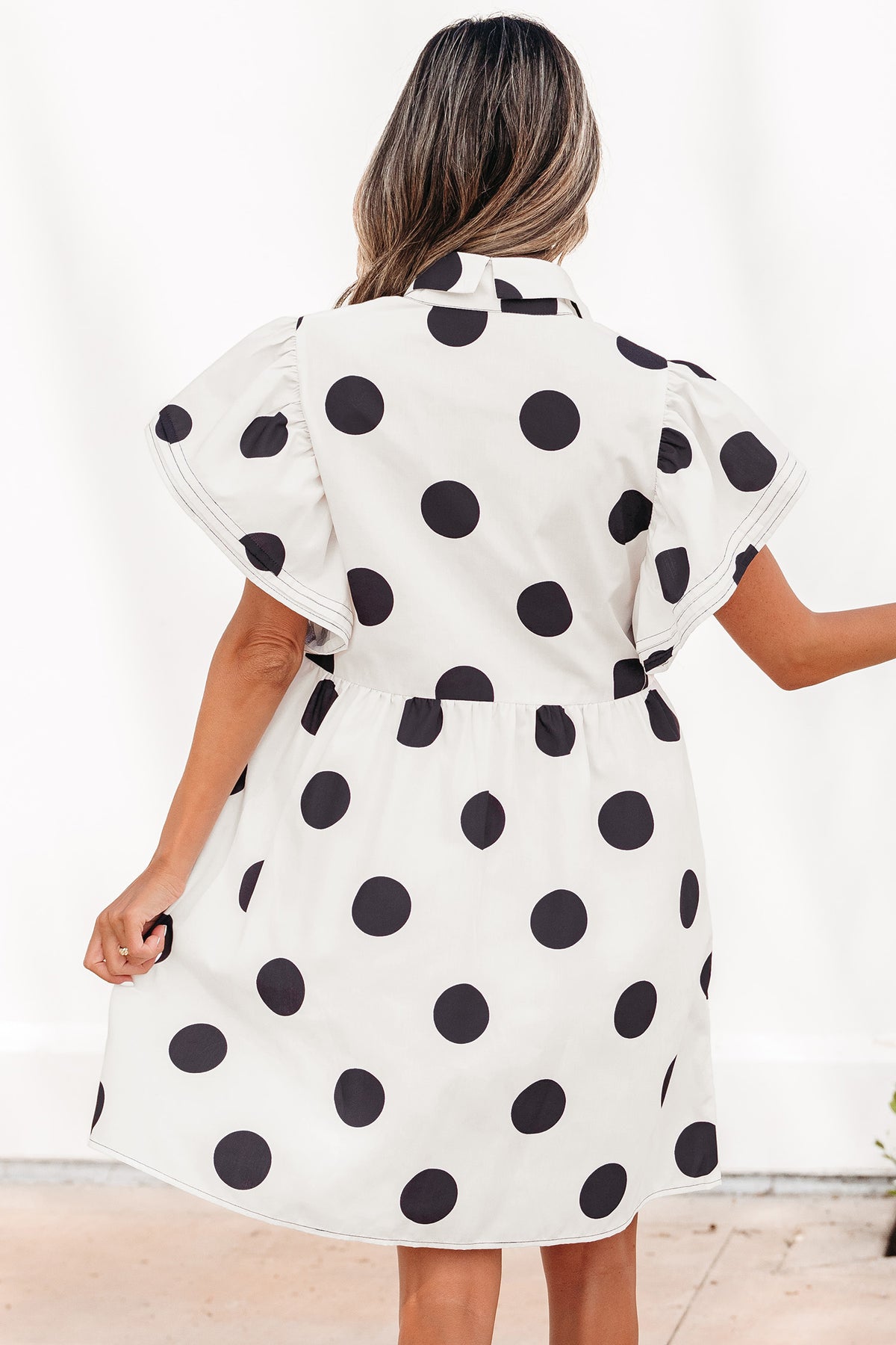 White polka dot print mini dress by Dear-Lover with ruffled short sleeves, half buttons, and a loose fit, perfect for casual wear.