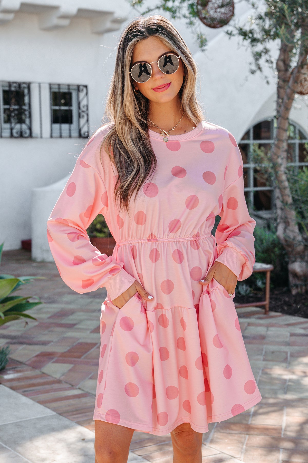 White polka dot printed long sleeve flared mini dress by Dear-Lover, showcasing its playful pattern and elegant fit.