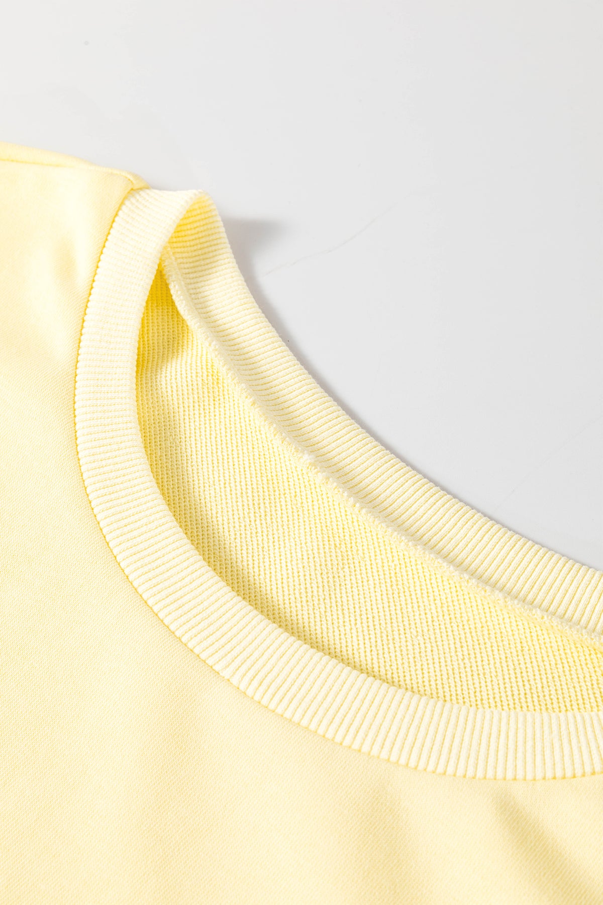 Yellow cream mini T-shirt dress with eyelet embroidery, lace splicing, and loose sleeves by Dear-Lover for a casual, stylish look.