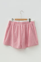 Plus size plaid print shorts with contrast trim, made of 100% cotton, featuring a comfortable fit and vibrant red design.