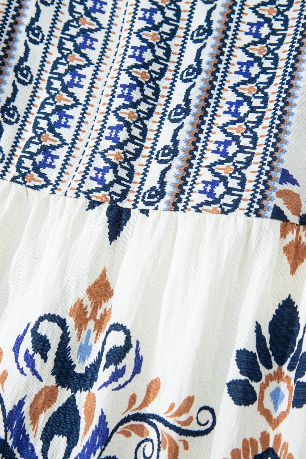 Sky blue plus size boho print mini dress with split neck and long sleeves, made of viscose and polyamide fabric.