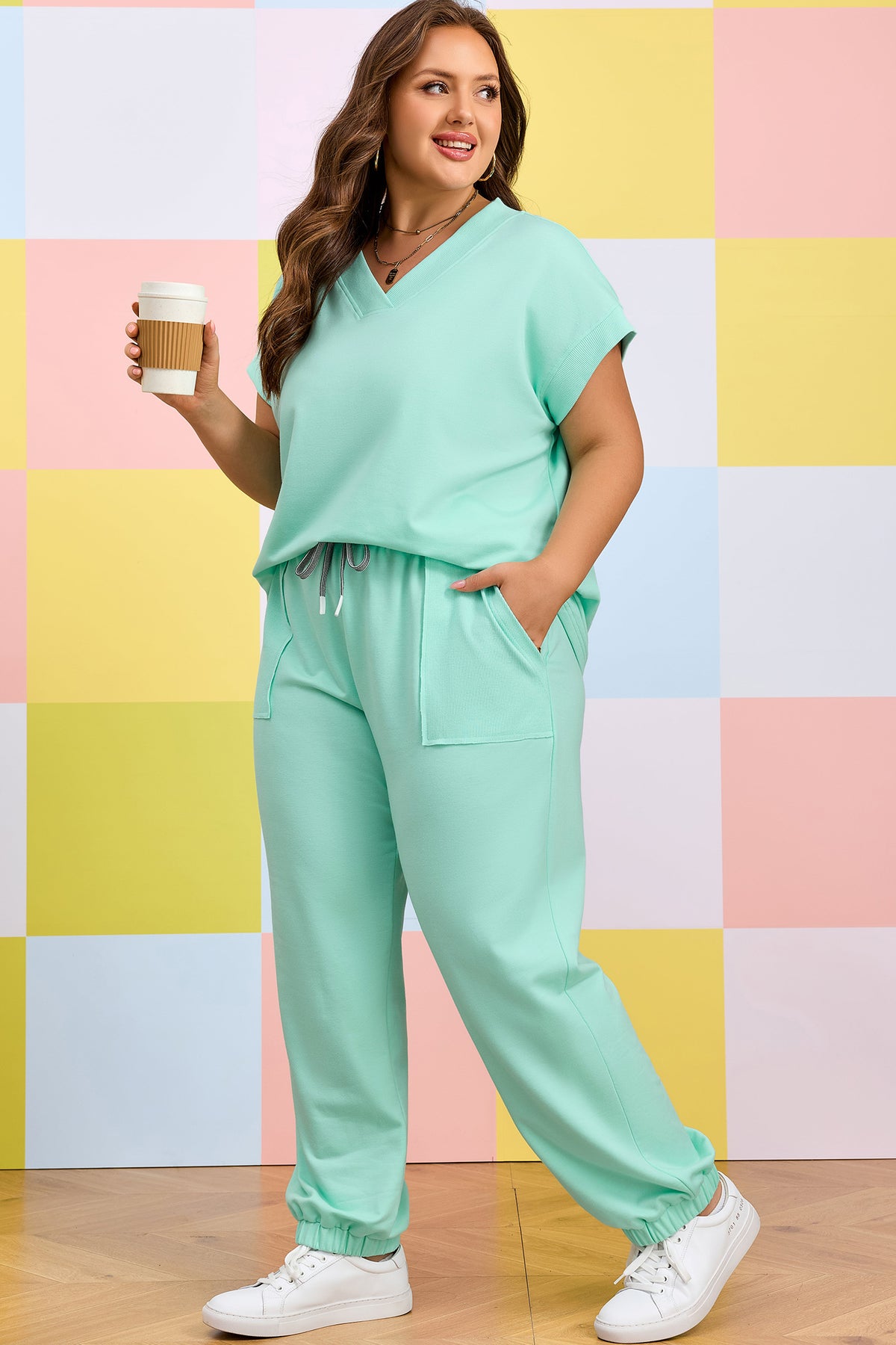 Plus size loungewear set featuring a solid V-neck tee and drawstring pants in polyester, cotton, and elastane fabric.
