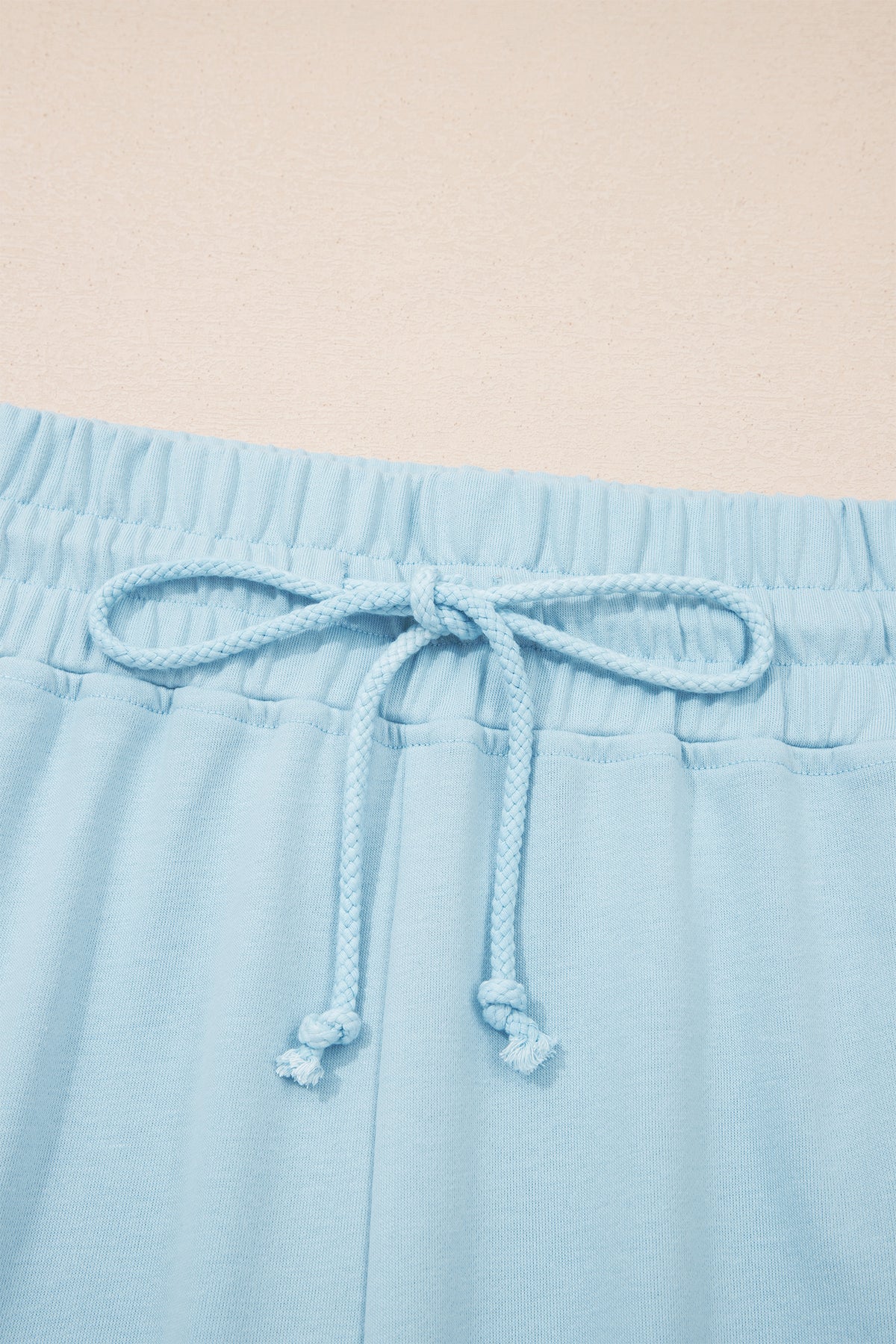 Plus size Mist Blue loungewear set with ribbed trim short sleeve top and drawstring loose pants, made of polyester and cotton blend.