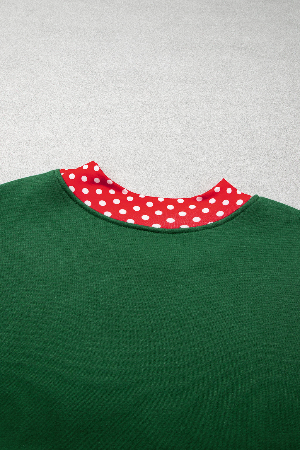 Red plus size sweatshirt with polka dot patchwork design and round neckline, featuring a cozy fit and casual style.