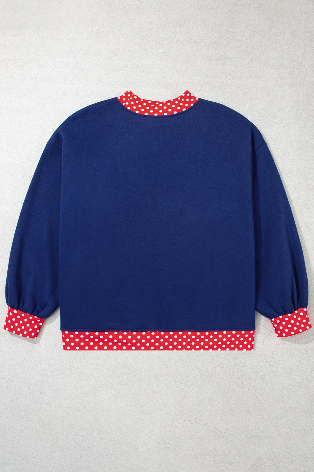 Red plus size sweatshirt with polka dot patchwork design and round neckline, featuring a comfortable fit and casual style.