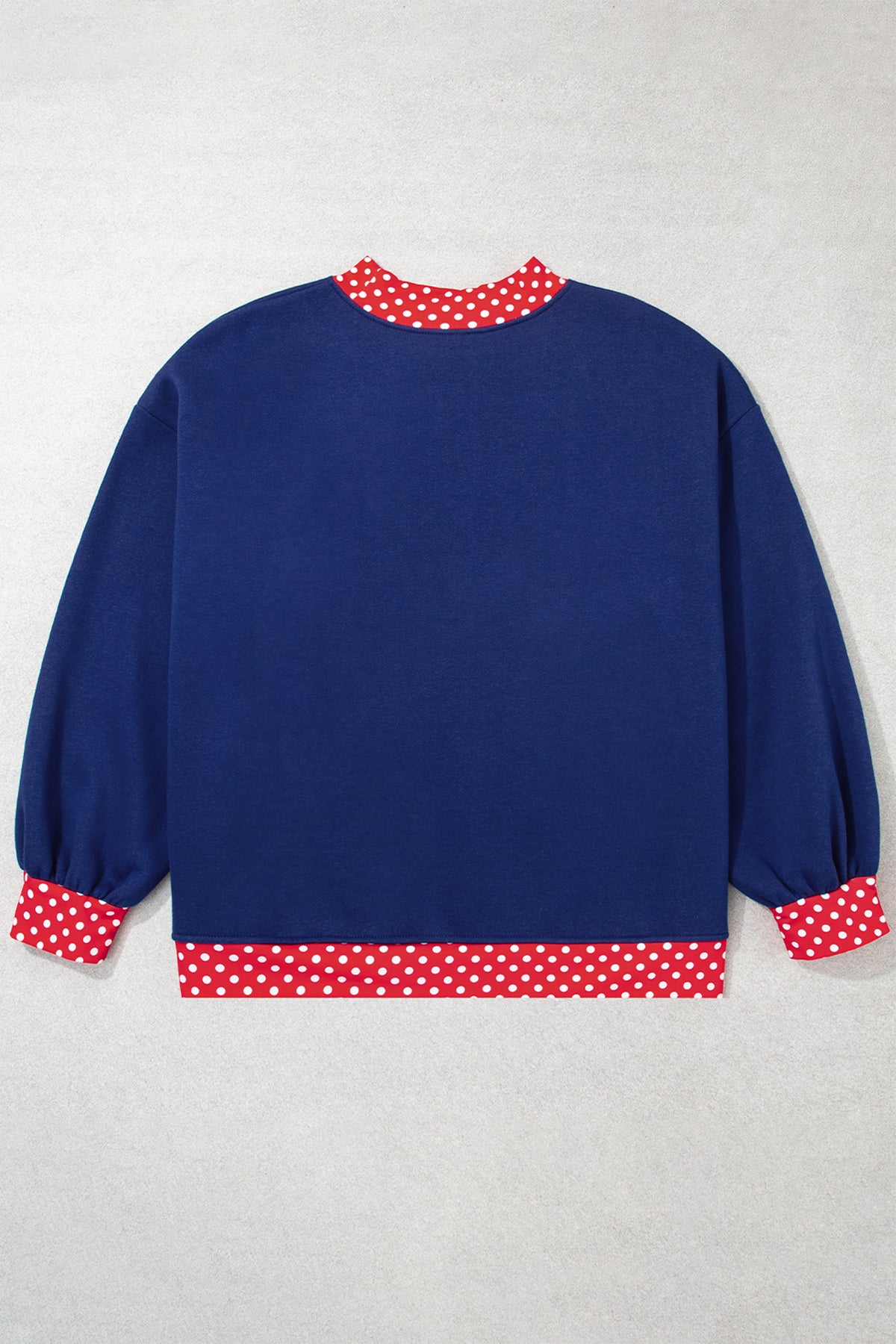 Red plus size sweatshirt with polka dot patchwork design and round neckline, featuring a comfortable fit and casual style.