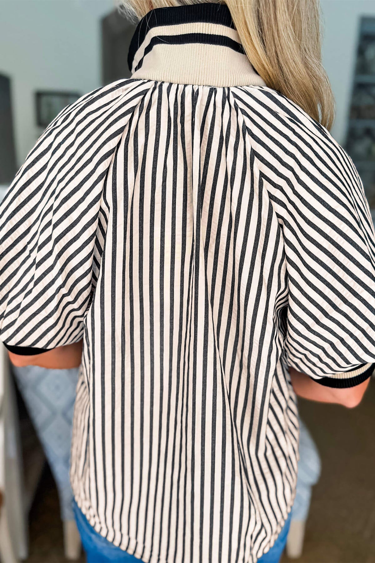 Black stripe polo collar blouse by Dear-Lover with half-zip, short puff sleeves, made of polyester and viscose fabric.