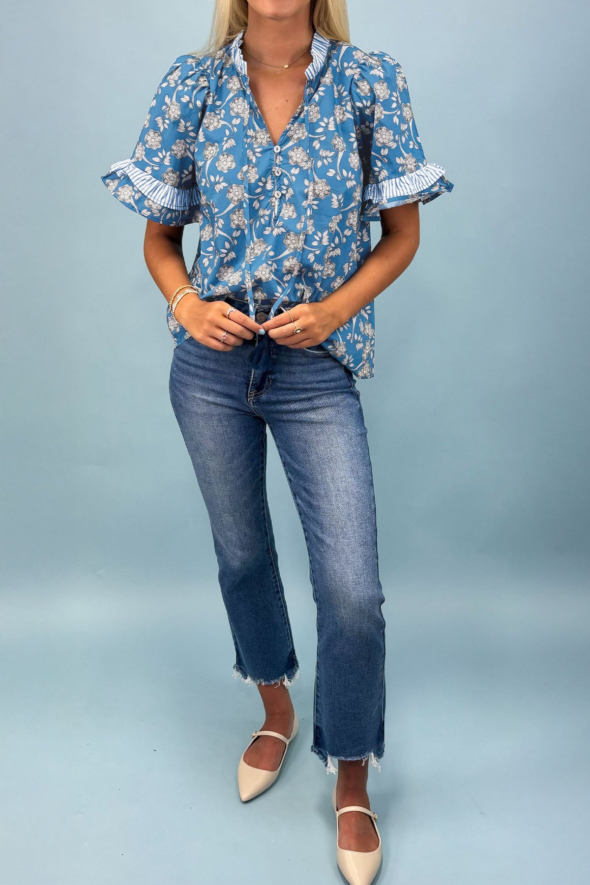Blue floral print blouse by Dear-Lover with button tie neck, striped detail, short sleeves, made from 100% cotton.