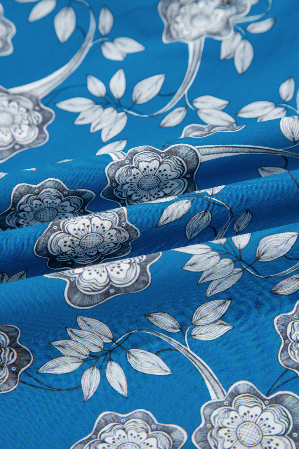 Blue floral print blouse by Dear-Lover with striped details, short sleeves, button tie neck, made of 100% cotton.