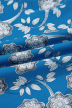 Blue floral print blouse by Dear-Lover with striped details, short sleeves, button tie neck, made of 100% cotton.