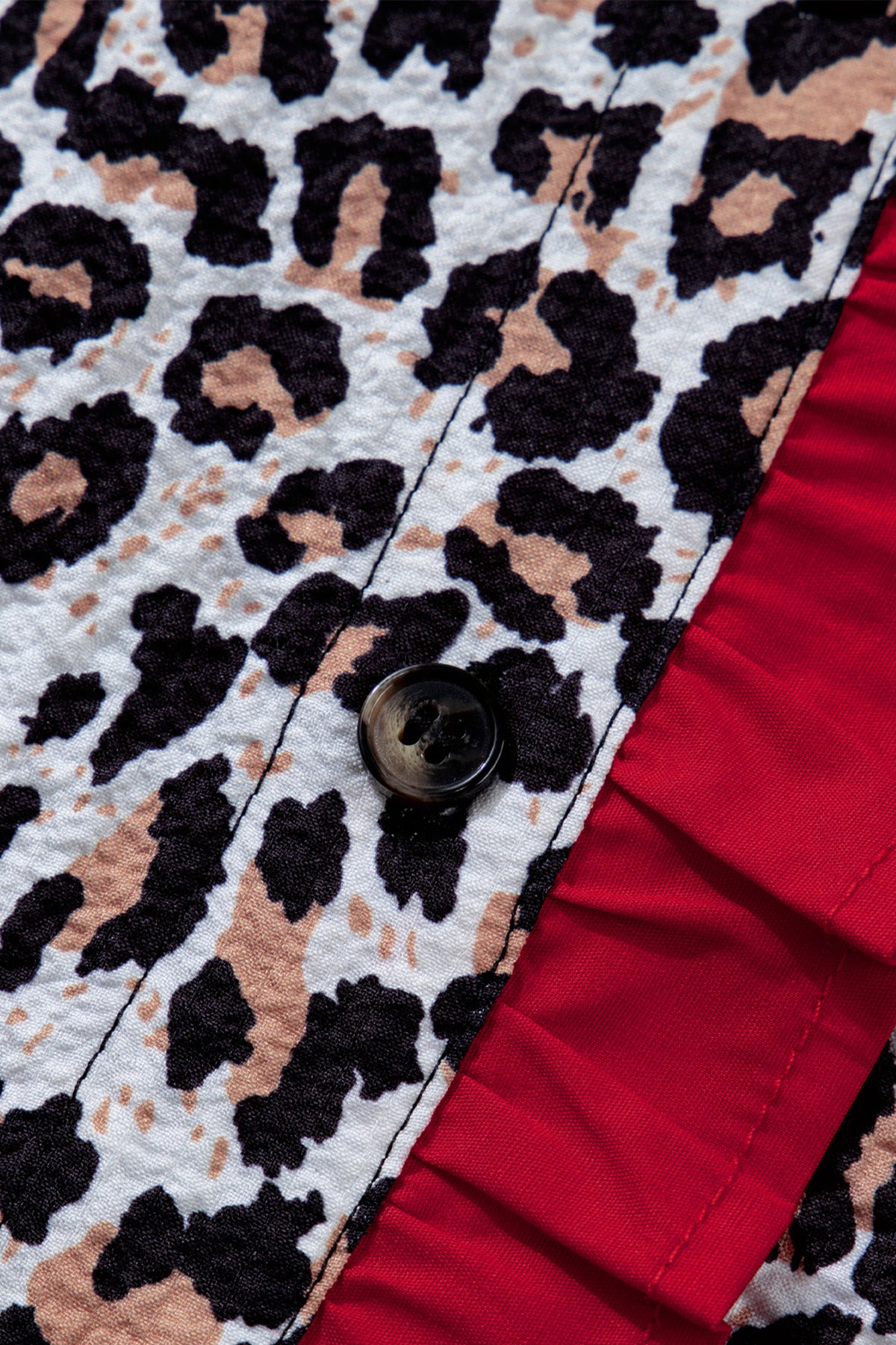 Khaki leopard print blouse with contrast frilled V-neck trim, long sleeves, and lightweight polyester fabric.