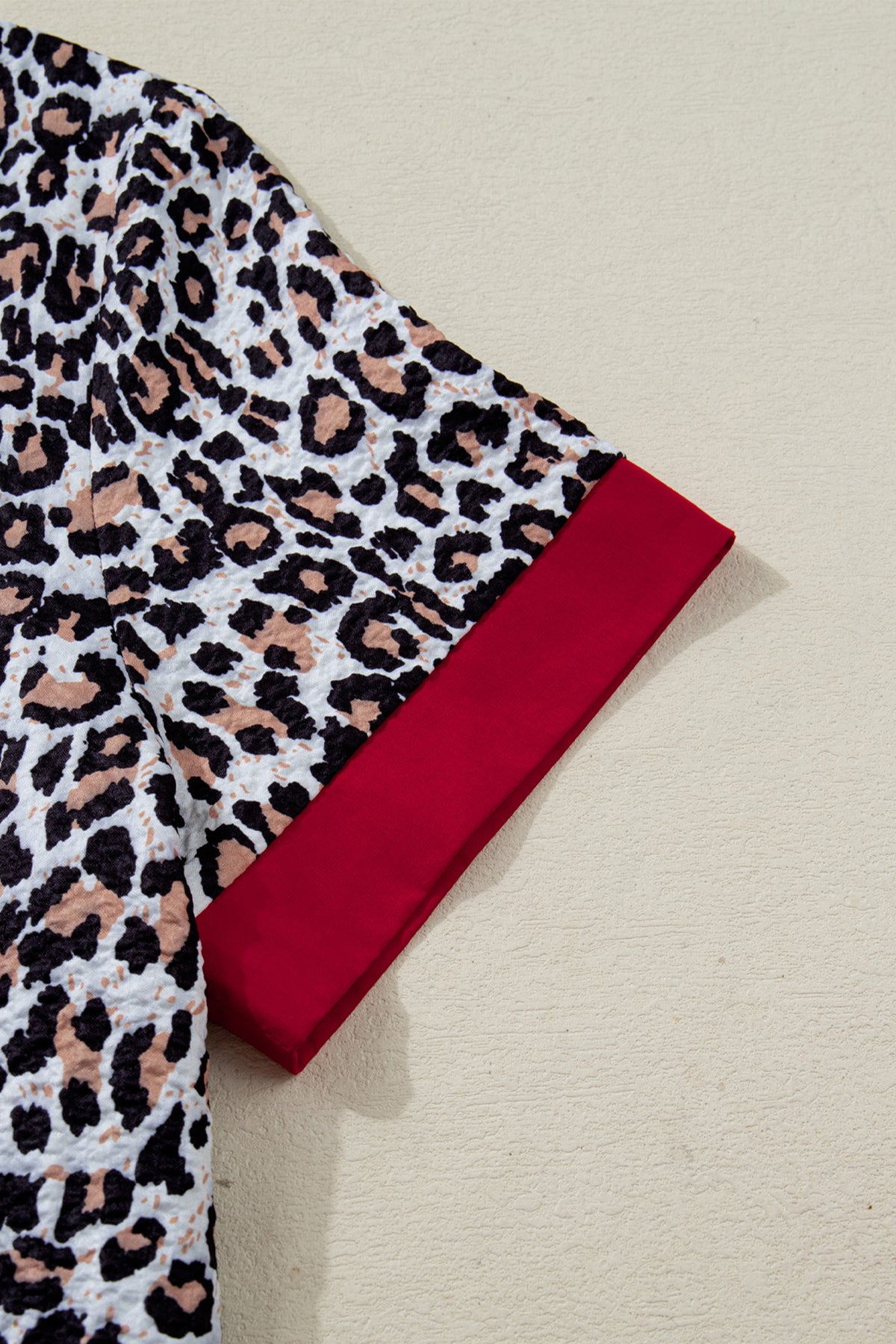 Khaki leopard print blouse with contrast frilled V-neck trim, long sleeves, silky polyester fabric, stylish and feminine.