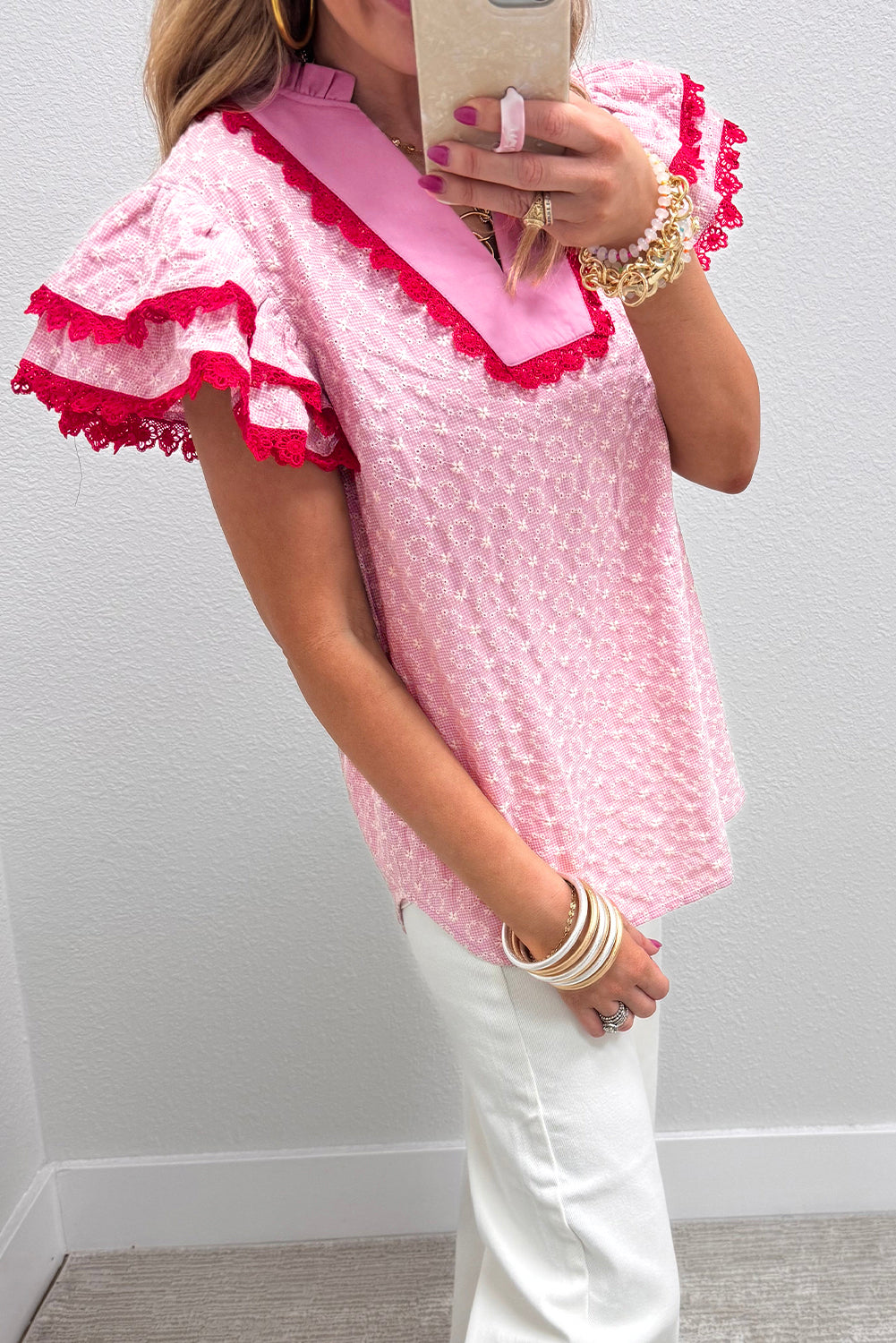 Pink eyelet embroidered flower texture blouse with contrast lace trim and flutter sleeves, perfect for stylish casual wear.