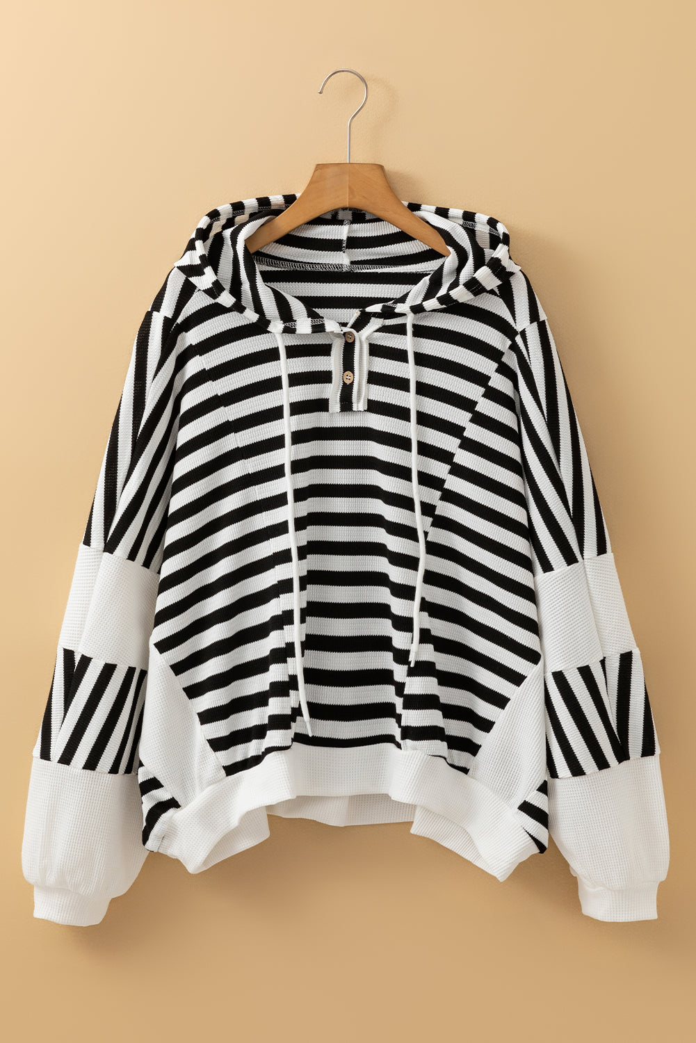 Black and white oversized striped Henley hooded top with dolman sleeves, made of polyester and elastane, by Dear-Lover.