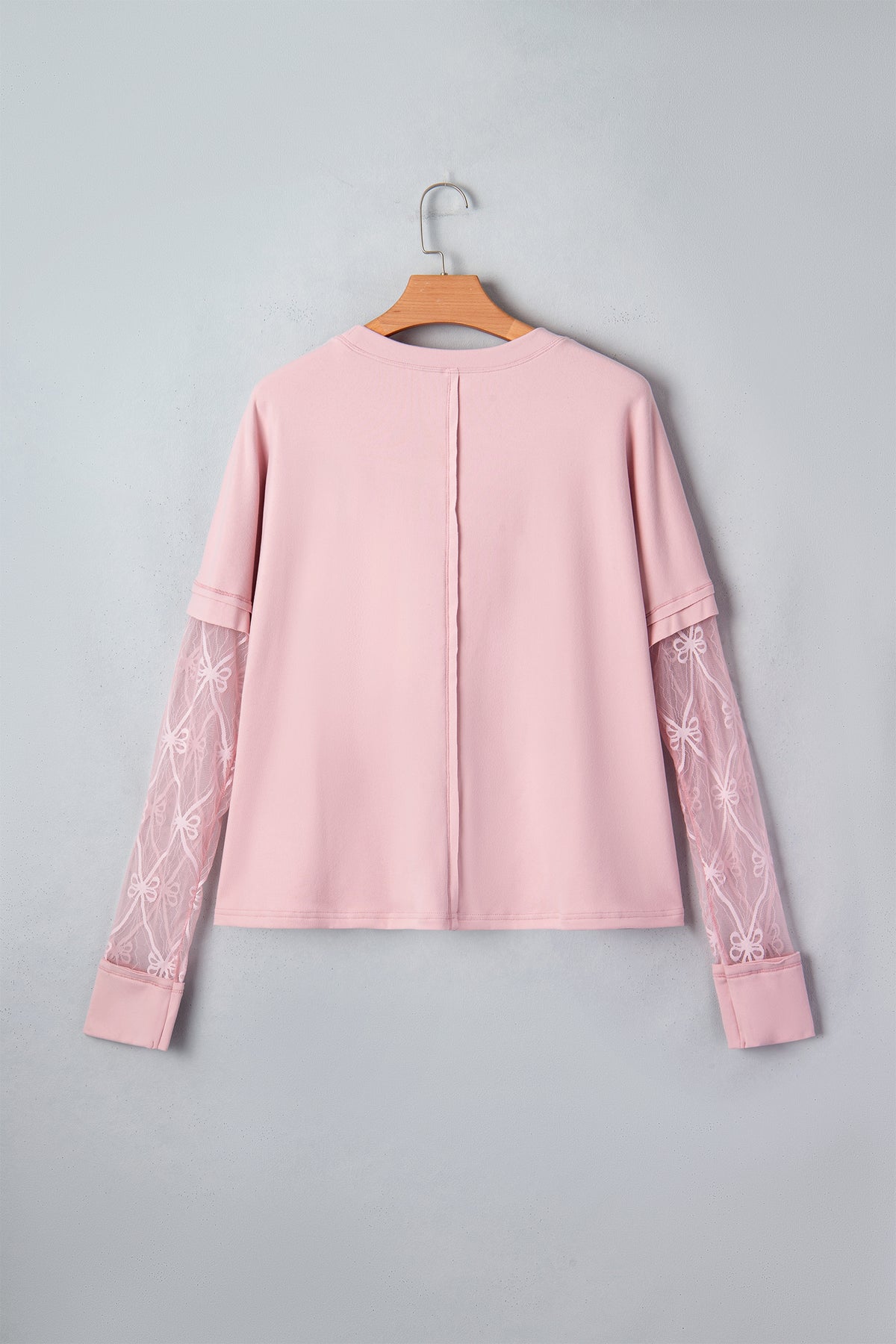 Light pink solid color long sleeve tee with textured patchwork and bow detail from Dear-Lover, made of polyester and elastane.