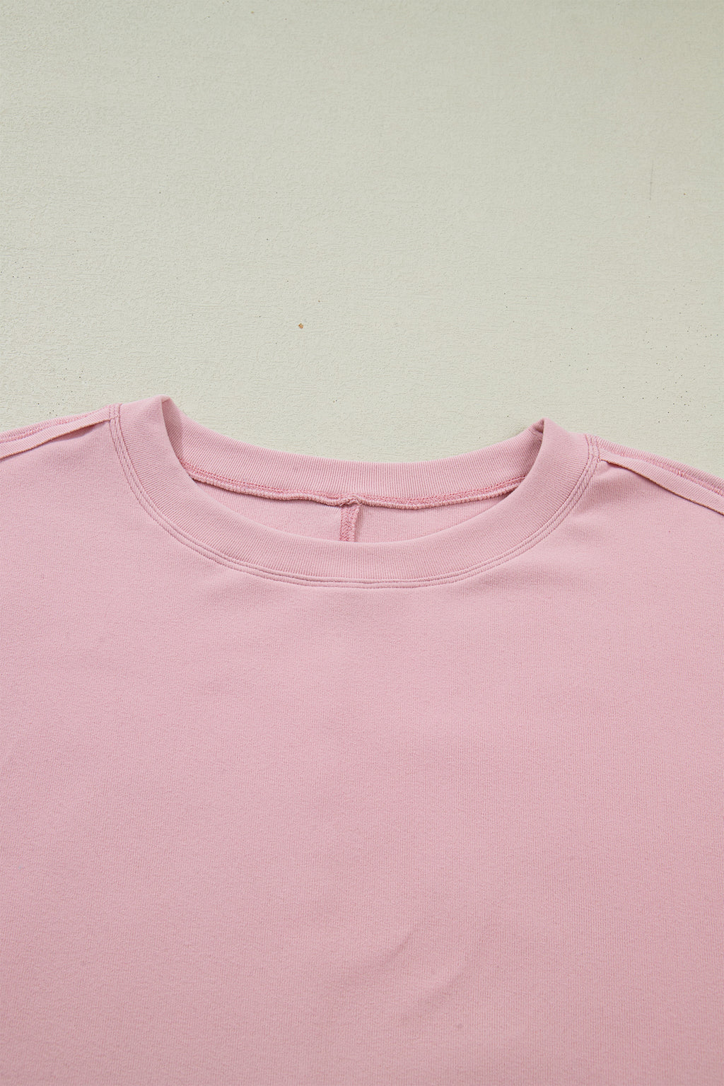 Light pink solid color long sleeve tee with textured patchwork and bow detail, from Dear-Lover Dropshipping.
