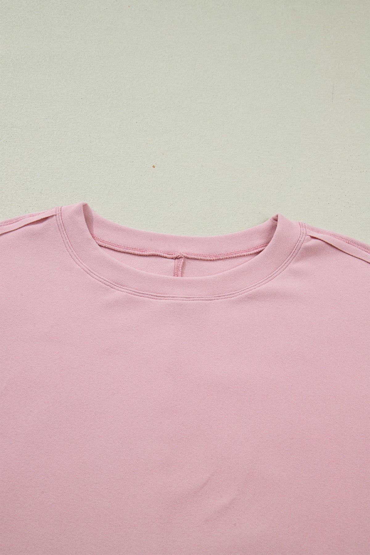 Light pink solid color long sleeve tee with textured patchwork and bow detail, from Dear-Lover Dropshipping.