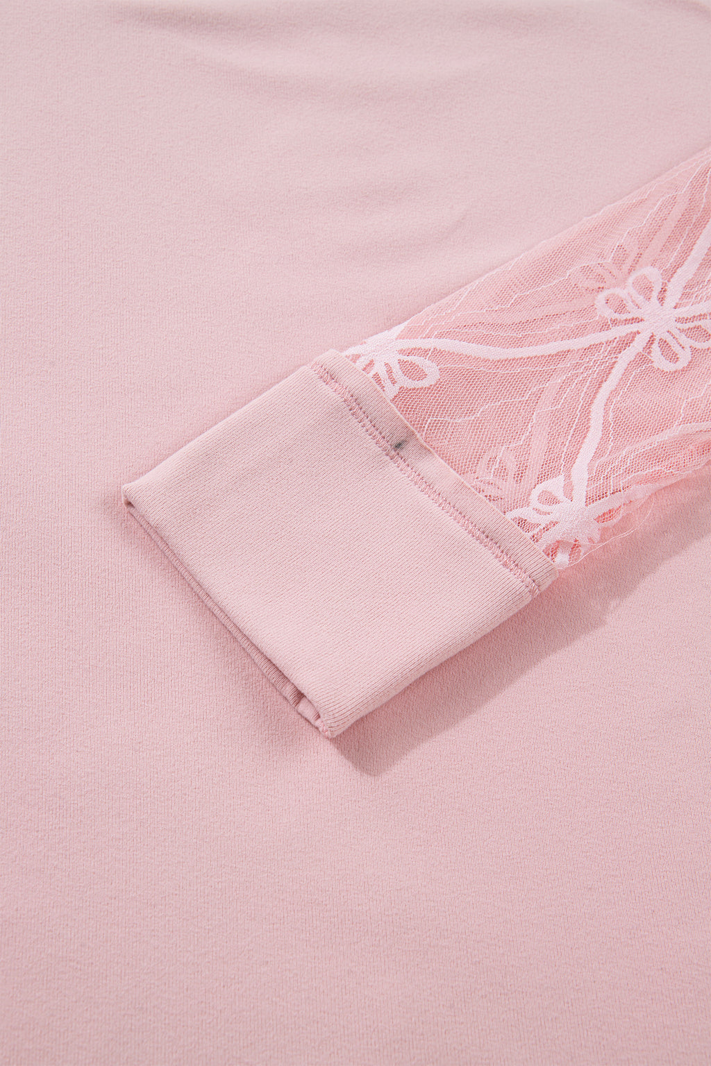 Light pink long sleeve tee from Dear-Lover Dropshipping featuring textured patchwork and a bow detail, made of polyester and elastane.