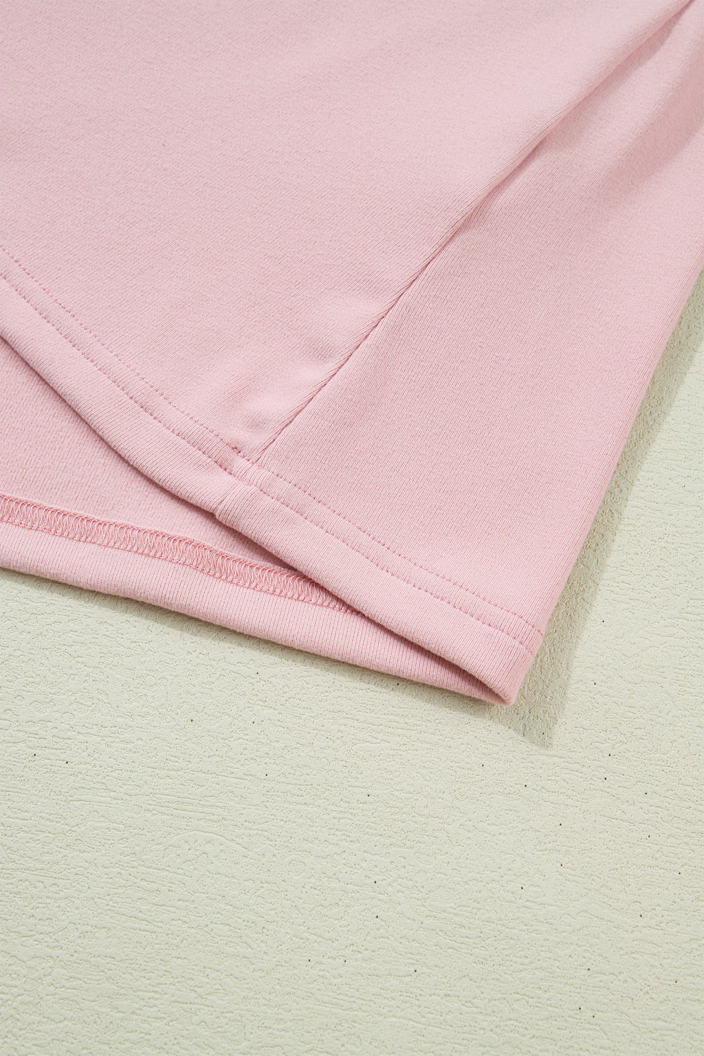 Light pink long sleeve top by Dear-Lover with textured bow patchwork design, made of polyester and elastane, featuring a solid color.