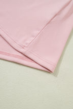 Light pink long sleeve top by Dear-Lover with textured bow patchwork design, made of polyester and elastane, featuring a solid color.