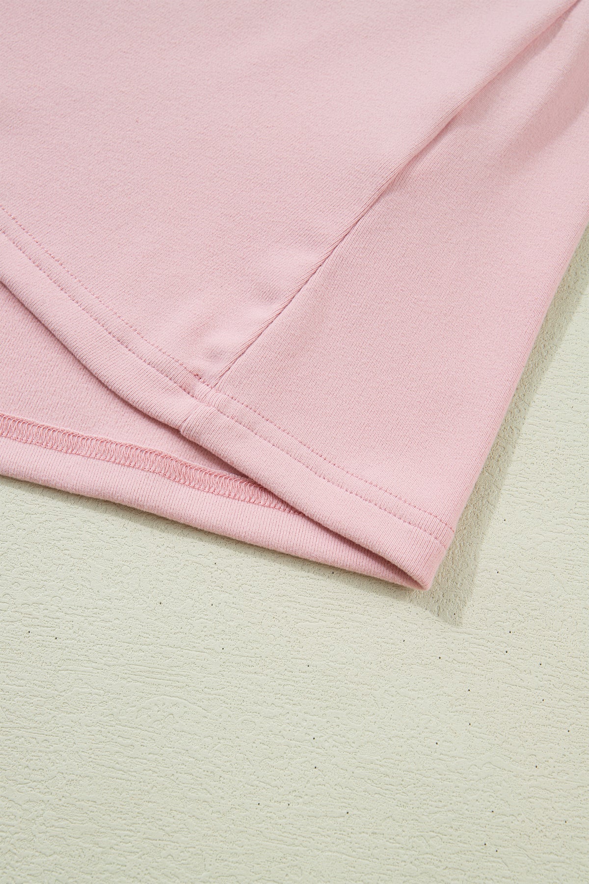 Light pink long sleeve top by Dear-Lover with textured bow patchwork design, made of polyester and elastane, featuring a solid color.