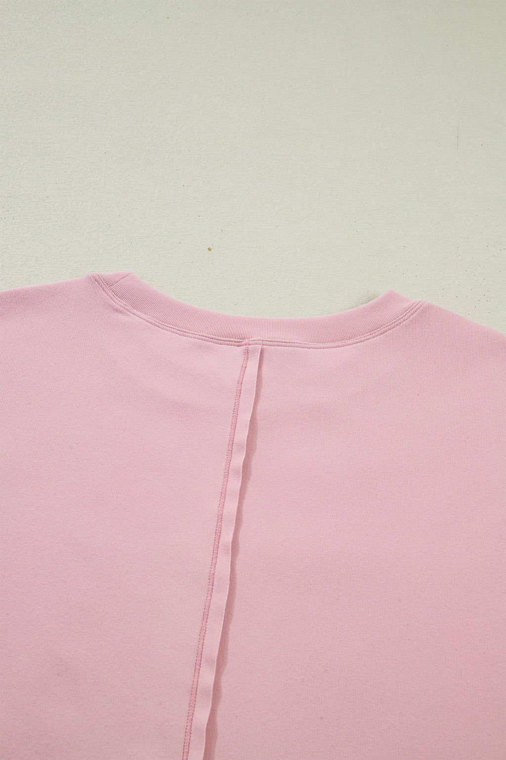 Light pink solid color long sleeve tee with textured patchwork and bow detail, from Dear-Lover Dropshipping.