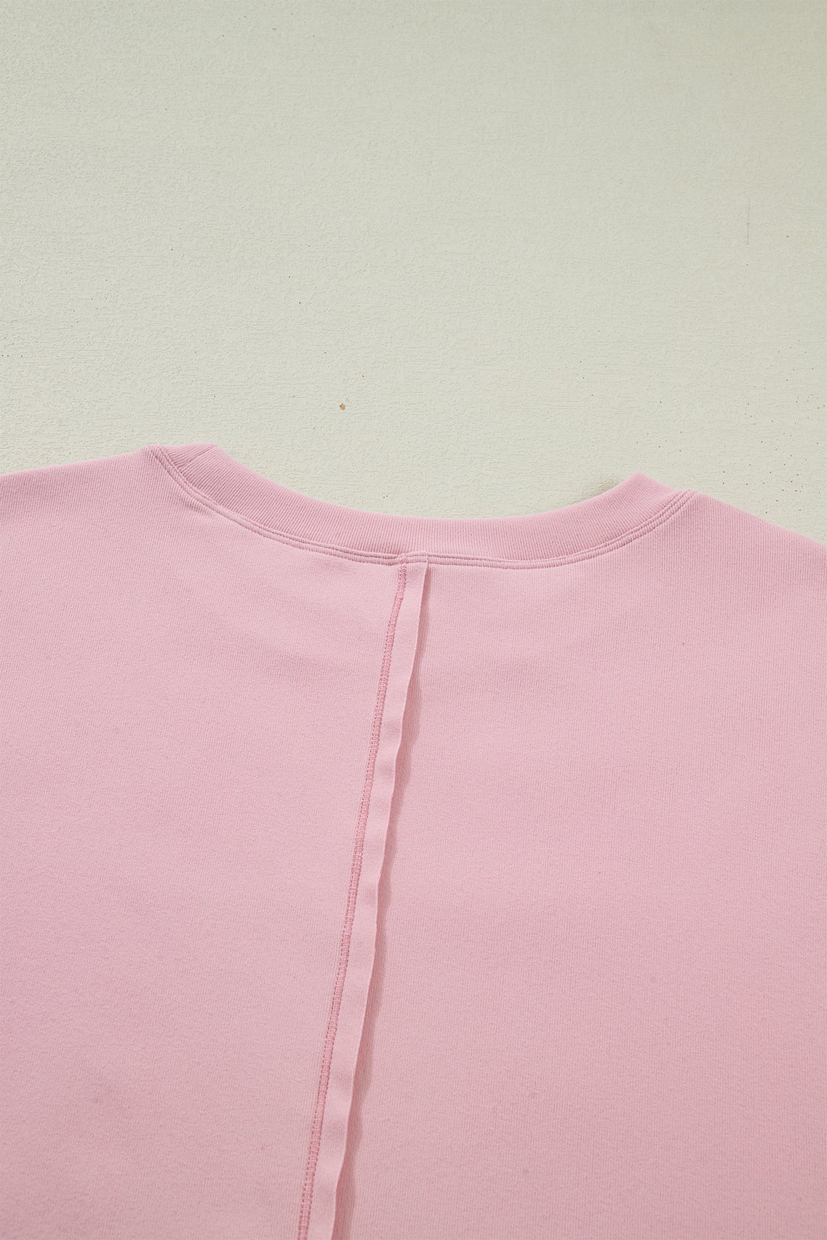 Light pink solid color long sleeve tee with textured patchwork and bow detail, from Dear-Lover Dropshipping.
