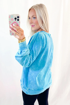 Blue mineral wash Dear-Lover sweatshirt with raw seams, double patched pockets, and a pullover design, made from cotton-polyester blend.