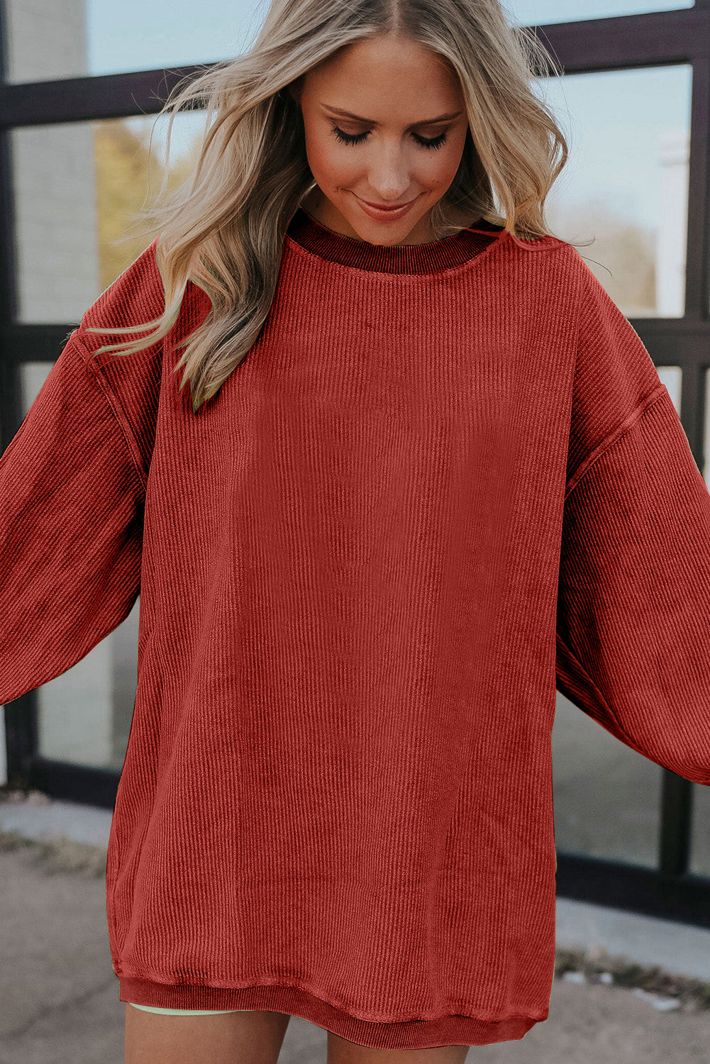 Orange ribbed corduroy oversized sweatshirt by Dear-Lover, featuring a relaxed fit and soft, textured fabric.