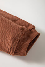 Orange ribbed corduroy oversized sweatshirt by Dear-Lover Dropshipping, showing the relaxed fit and textured fabric detail.
