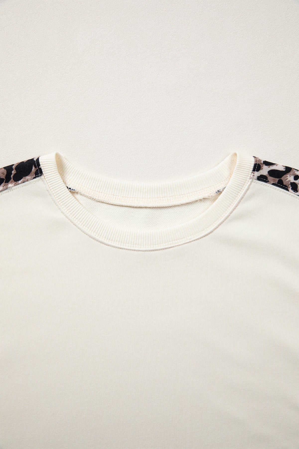 Beige leopard block patchwork short sleeve top with uneven hem from Dear-Lover, made of cotton and polyester fabric.