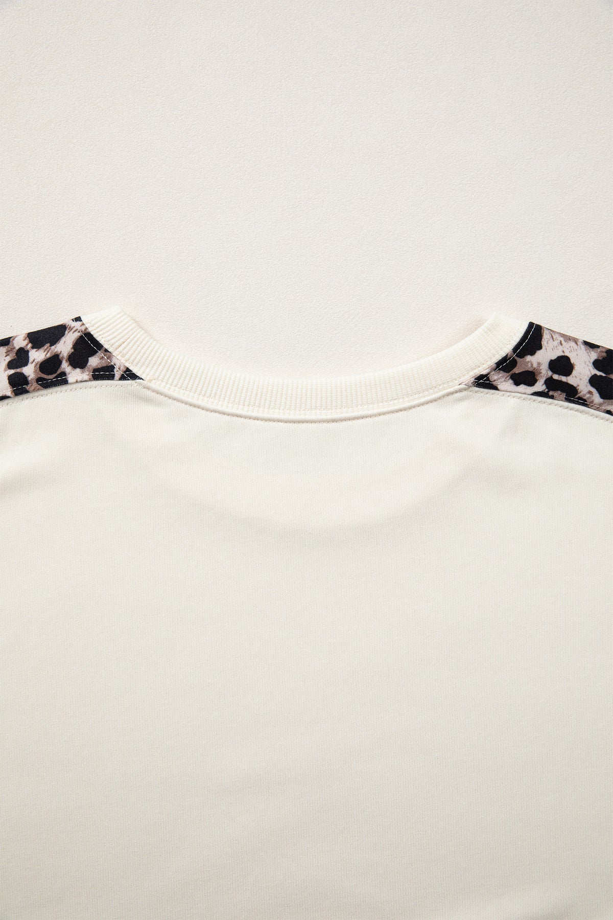 Beige leopard patchwork short sleeve top with uneven hem, made of cotton and polyester, by Dear-Lover Dropshipping.