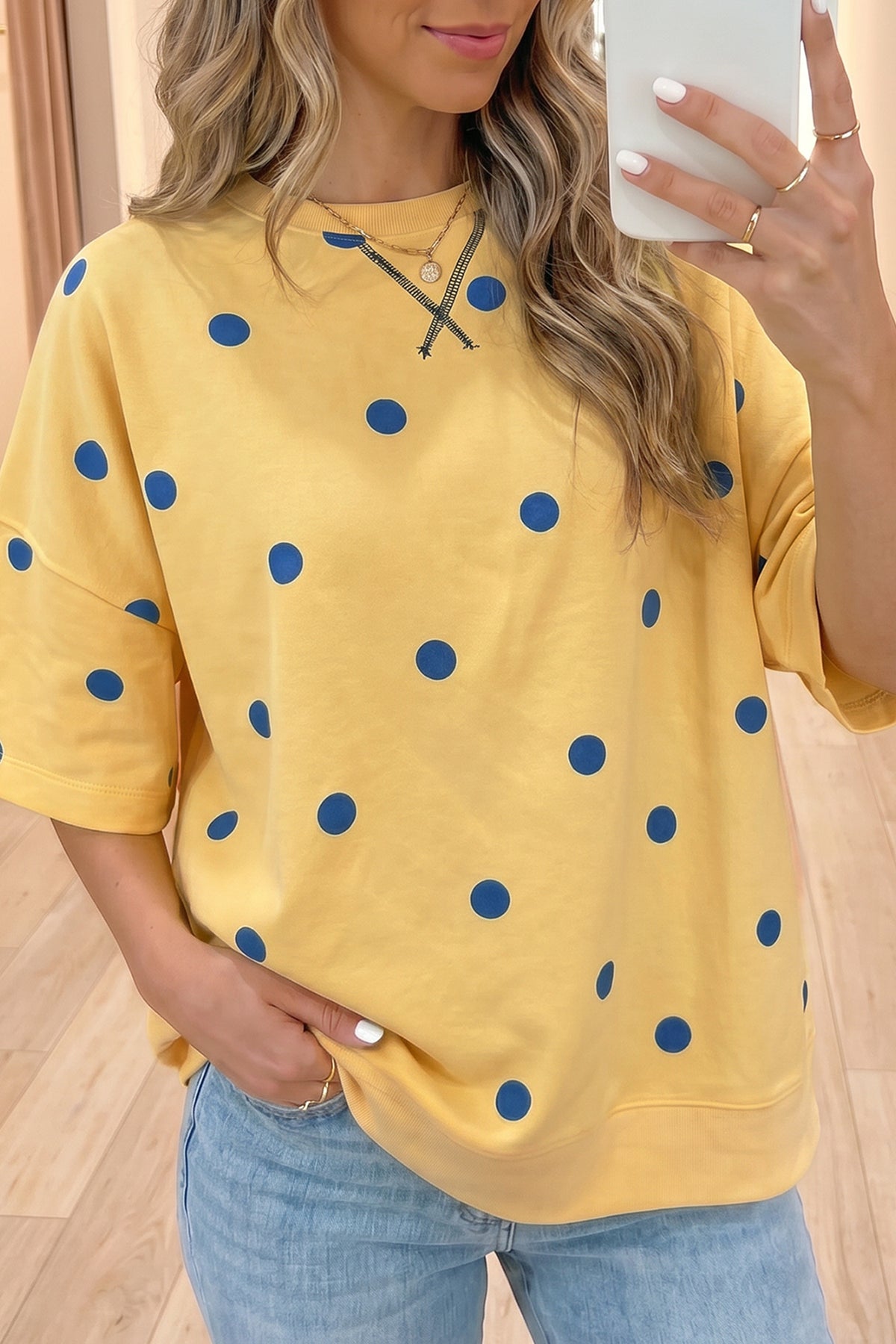 Yellow polka dot print oversized tee from Dear-Lover with crossed seam detail, made of polyester and elastane, casual and stylish top.