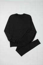 Black solid color oversized slit sweatshirt and ribbed leggings two-piece set by Dear-Lover, casual comfortable loungewear ensemble.