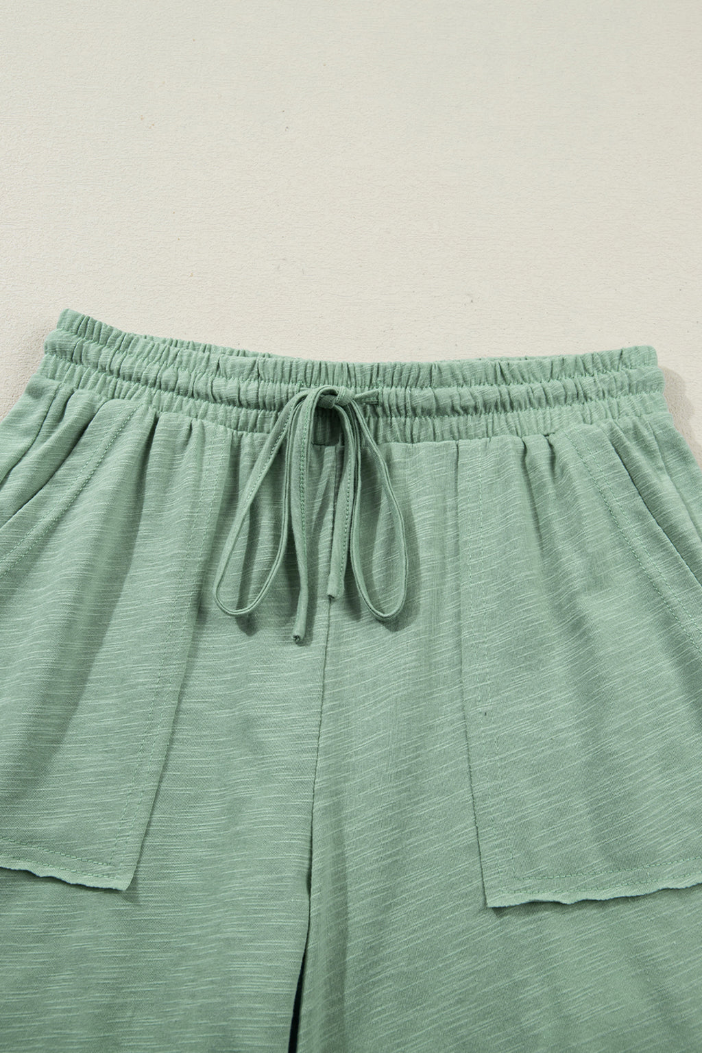 Dear-Lover two-piece set with a cuffed short-sleeve tee and drawstring pants, featuring raw seam and patch pocket details.