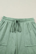 Dear-Lover two-piece set with a cuffed short-sleeve tee and drawstring pants, featuring raw seam and patch pocket details.