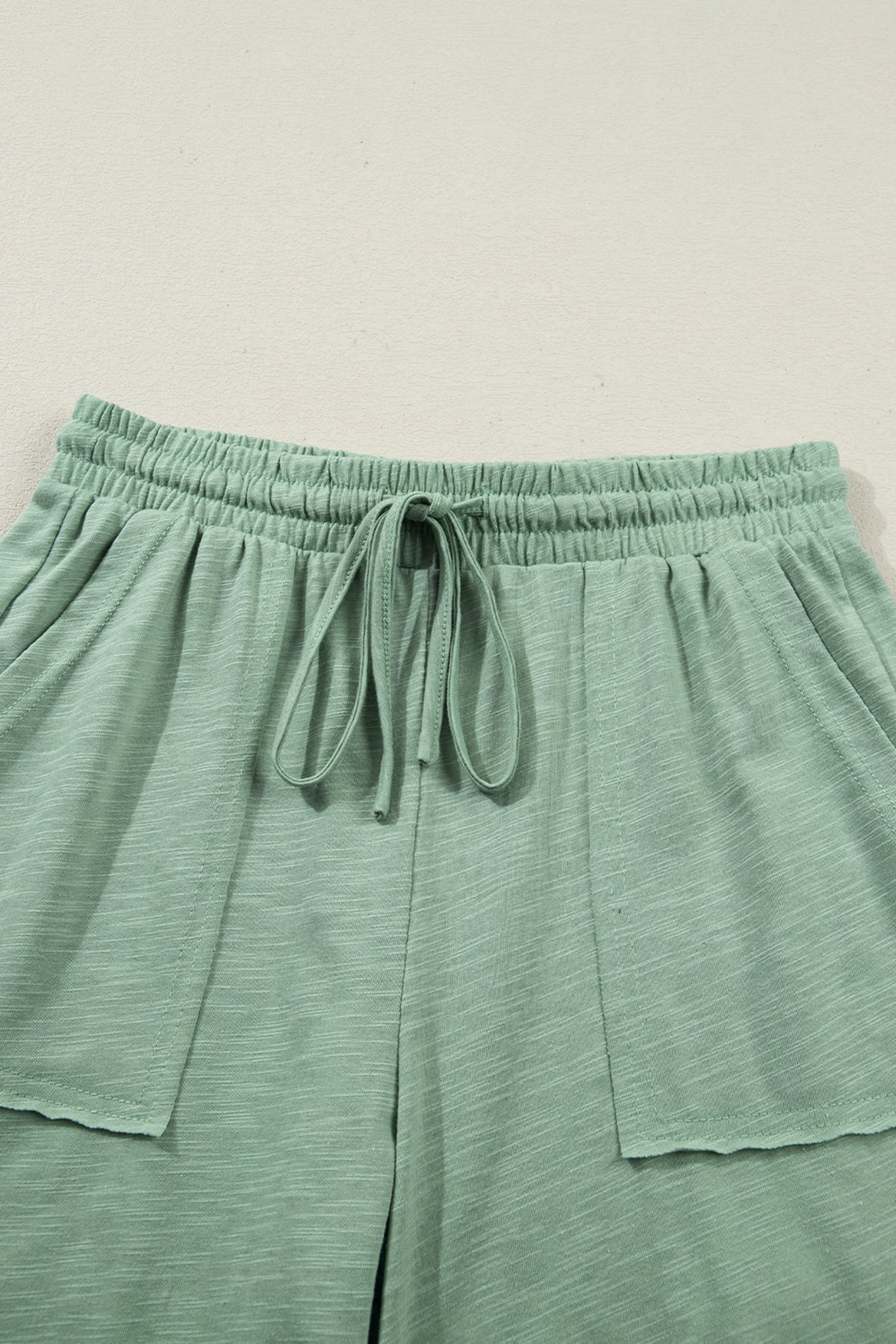 Dear-Lover two-piece set with a cuffed short-sleeve tee and drawstring pants, featuring raw seam and patch pocket details.