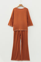 Dear-Lover orange two-piece set with contrast stitching, V-neck top with buttons, and drawstring flare pants, polyester blend.