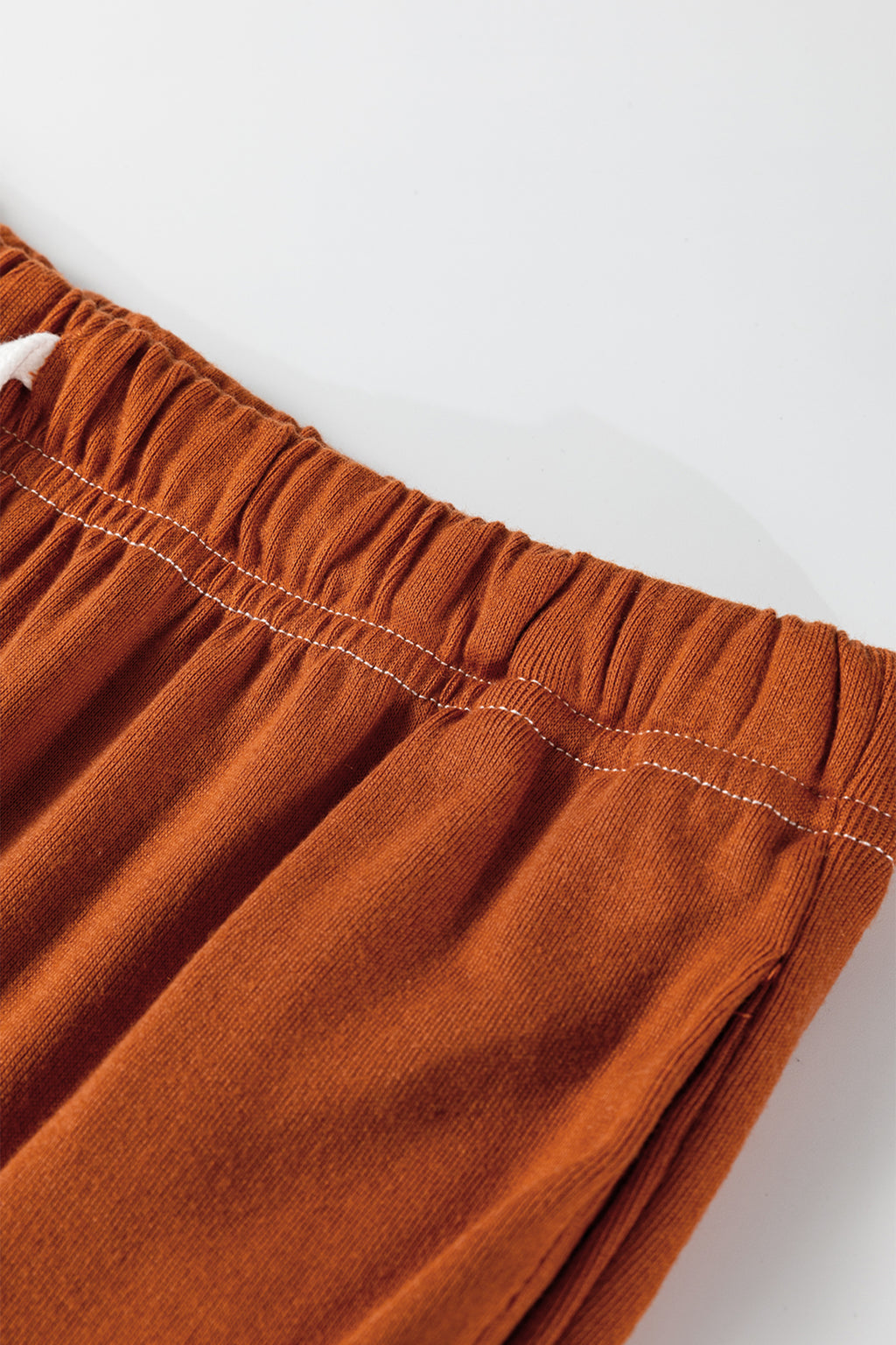 Grapefruit orange two-piece set with contrast stitching, buttoned V-neck top and drawstring flare pants from Dear-Lover Dropshipping