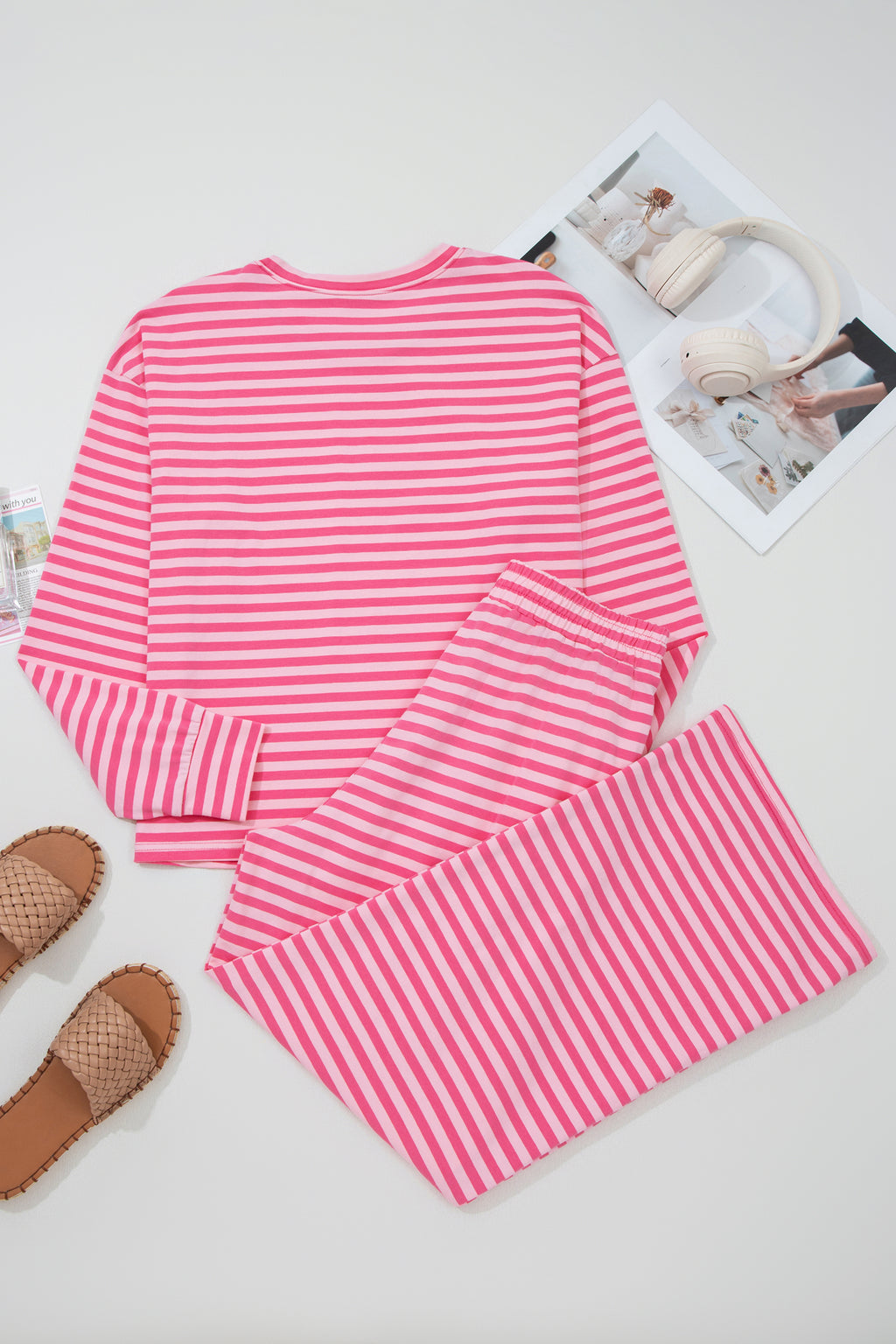 Pink stripe two-piece set with drop shoulder round neck top and buttoned straight pants, made of cotton and elastane for comfort.