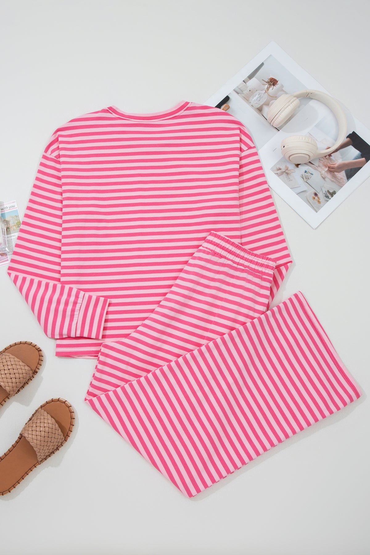 Pink stripe two-piece set with drop shoulder round neck top and buttoned straight pants, made of cotton and elastane for comfort.