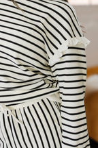White stripe ruffle trim drop shoulder top and loose drawstring pant set by Dear-Lover, made of cotton and polyester, two-piece outfit.