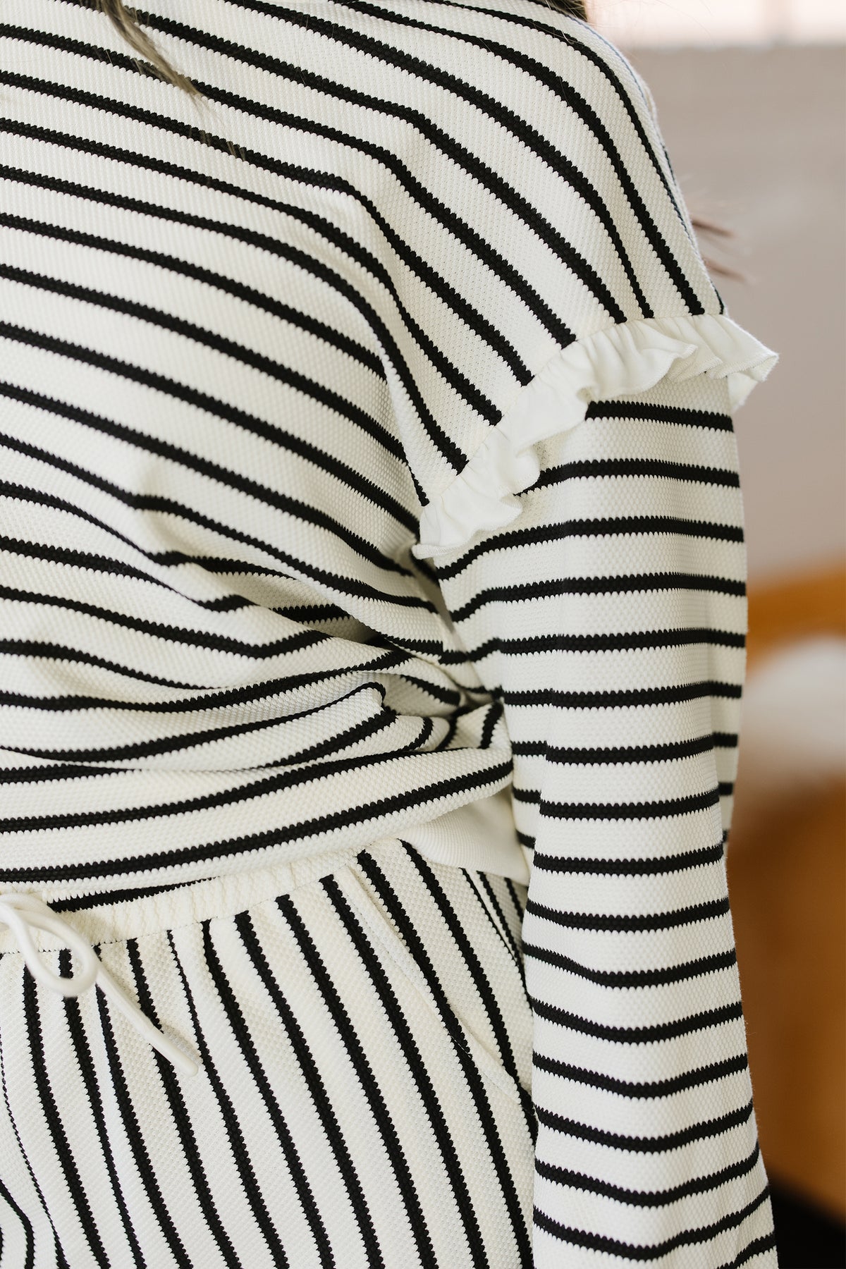 White stripe ruffle trim drop shoulder top and loose drawstring pant set by Dear-Lover, made of cotton and polyester, two-piece outfit.