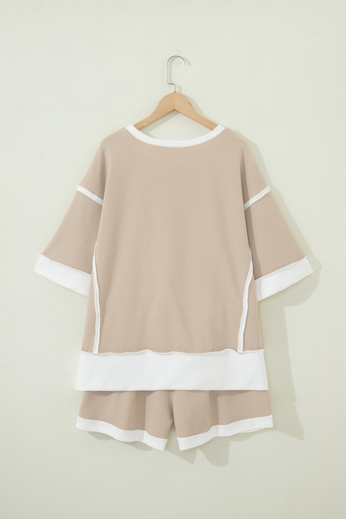 Beige raw edge color block patchwork two-piece set with oversized tee and drawstring loose shorts, made of cotton-polyester blend.