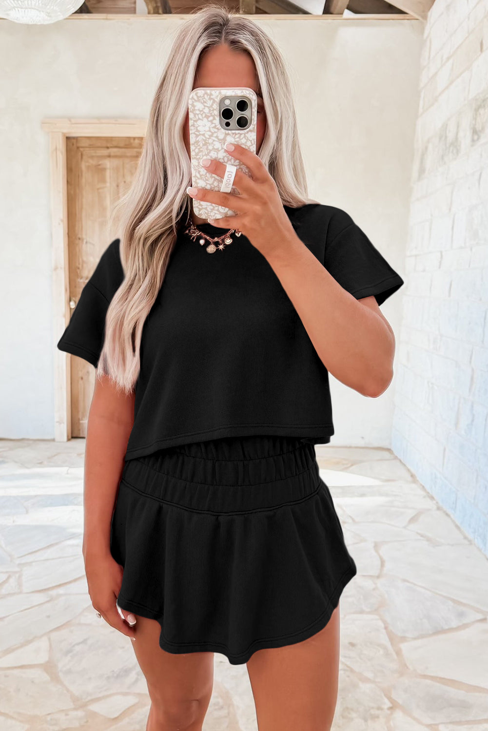 Dear-Lover Blossom 2-piece cropped tee and ruffle high-waist skort set, featuring floral print and comfortable fabric blend.